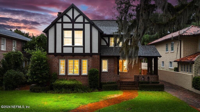 back house at dusk with a yard