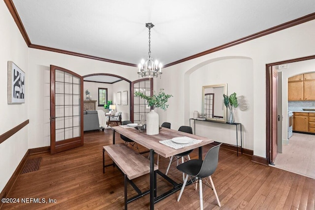 dining area with crown molding, a chandelier, and dark hardwood / wood-style floors