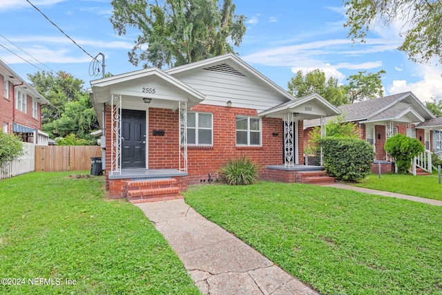 bungalow-style home with a front yard