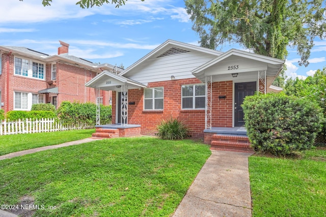 bungalow-style home with a front yard