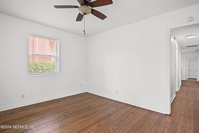 unfurnished room with ceiling fan and dark hardwood / wood-style flooring