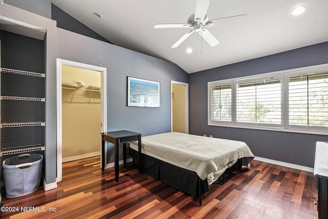 bedroom featuring a closet, ceiling fan, dark hardwood / wood-style flooring, and vaulted ceiling