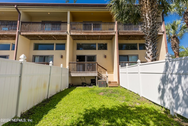 exterior space with a yard and a balcony