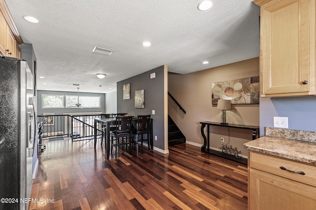 dining room with a chandelier, dark hardwood / wood-style flooring, and a textured ceiling