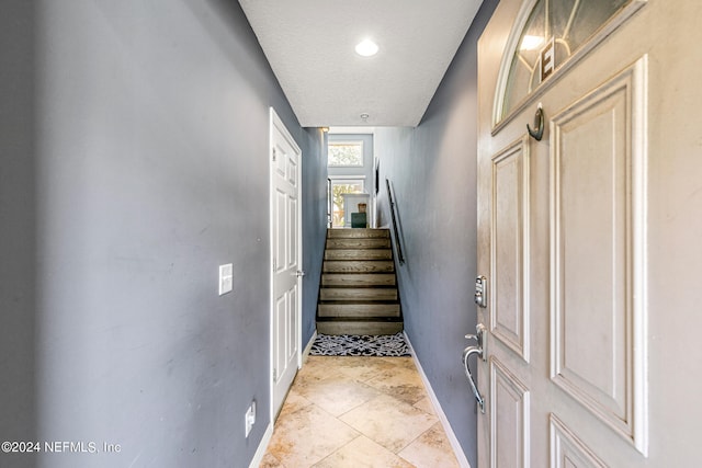 stairway with a textured ceiling