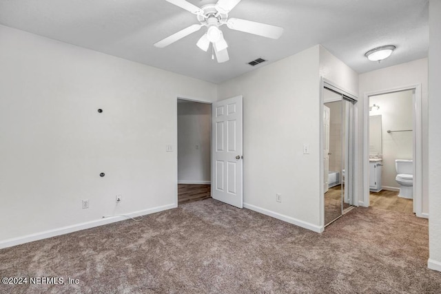 unfurnished bedroom with carpet flooring, visible vents, and baseboards