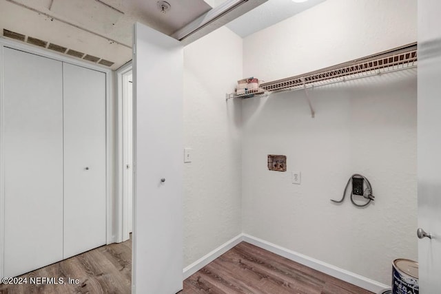 laundry room with laundry area, baseboards, and wood finished floors