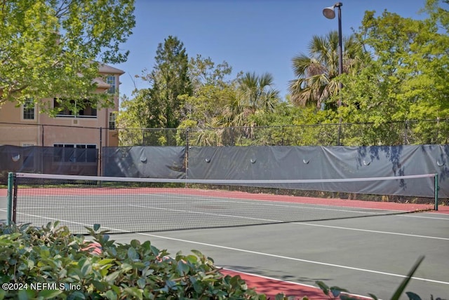 view of sport court featuring fence