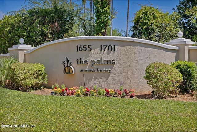 community / neighborhood sign with a lawn