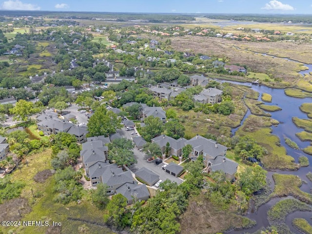 drone / aerial view featuring a residential view and a water view