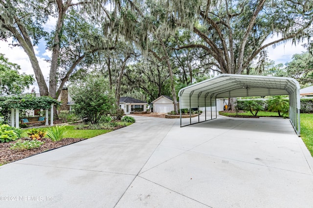 view of parking / parking lot featuring a carport and concrete driveway