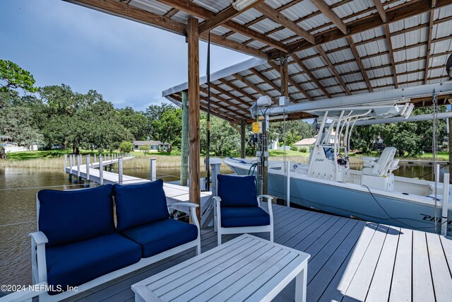 wooden terrace featuring a dock and a water view