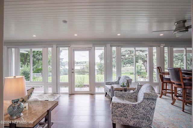 sunroom with ceiling fan and a wealth of natural light