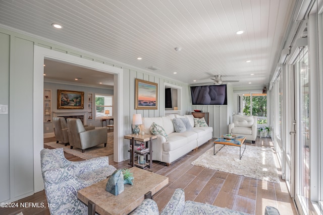 living room featuring wood ceiling, ceiling fan, crown molding, and wood-type flooring