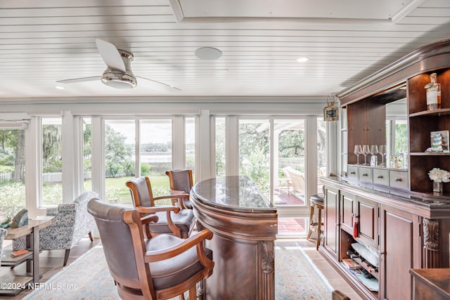 sunroom / solarium featuring wooden ceiling and a ceiling fan