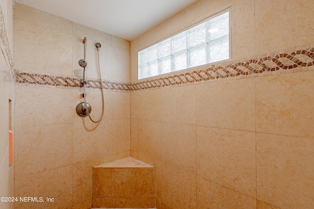 full bath with tiled shower