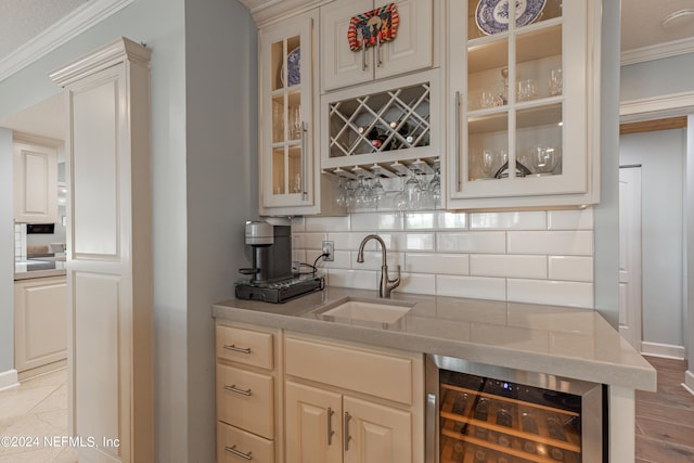 bar with beverage cooler, a sink, tasteful backsplash, indoor wet bar, and crown molding