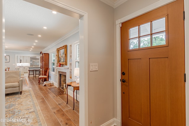 foyer featuring light hardwood / wood-style flooring and ornamental molding