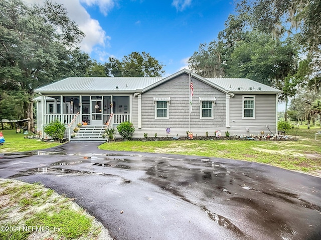 ranch-style home with a porch and a front yard