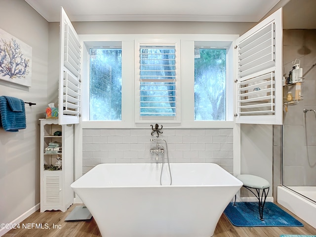 bathroom with hardwood / wood-style flooring and a washtub