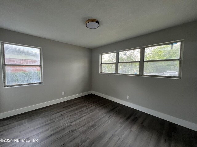 empty room with hardwood / wood-style flooring