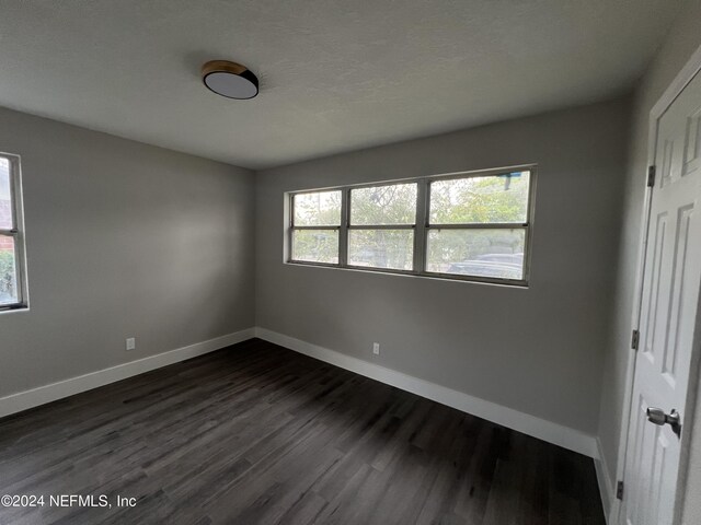 unfurnished room with hardwood / wood-style flooring