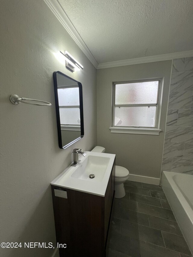 bathroom with vanity, tile patterned flooring, crown molding, a textured ceiling, and toilet