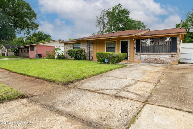 ranch-style home featuring a front yard