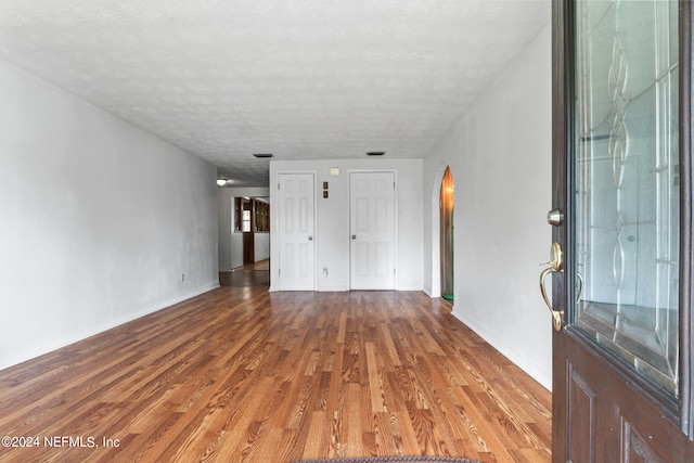 interior space with hardwood / wood-style floors and a textured ceiling