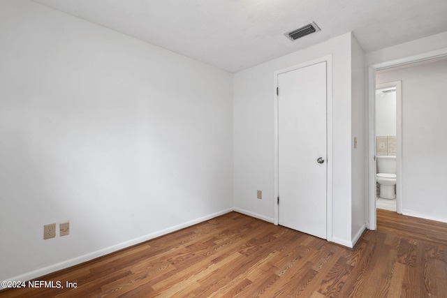 unfurnished bedroom featuring hardwood / wood-style flooring