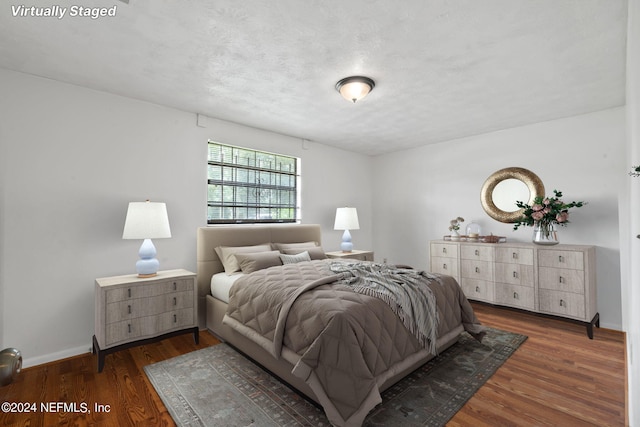 bedroom featuring dark hardwood / wood-style flooring