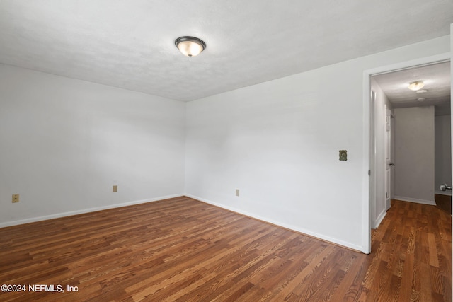 spare room featuring dark hardwood / wood-style floors