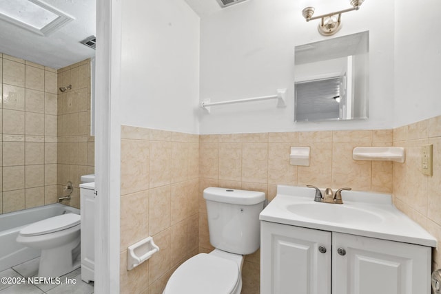 full bathroom with tile walls, tile patterned flooring, and toilet