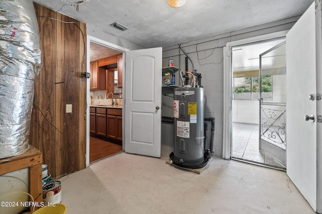 utility room with sink and water heater