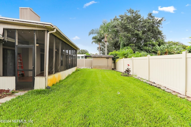 view of yard featuring a fenced backyard and a sunroom