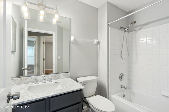 full bath featuring a textured ceiling, vanity, toilet, and bathing tub / shower combination