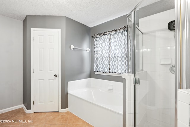 bathroom with a stall shower, tile patterned flooring, and a bath