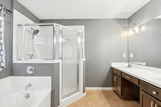 full bath with double vanity, a sink, a textured ceiling, a shower stall, and a bath