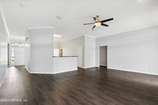 spare room featuring dark wood-type flooring, visible vents, crown molding, and a ceiling fan