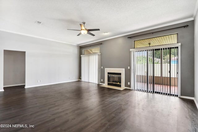 unfurnished living room with visible vents, ornamental molding, dark wood-type flooring, and a fireplace with flush hearth