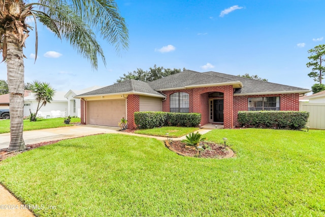 single story home with brick siding, concrete driveway, roof with shingles, an attached garage, and a front yard