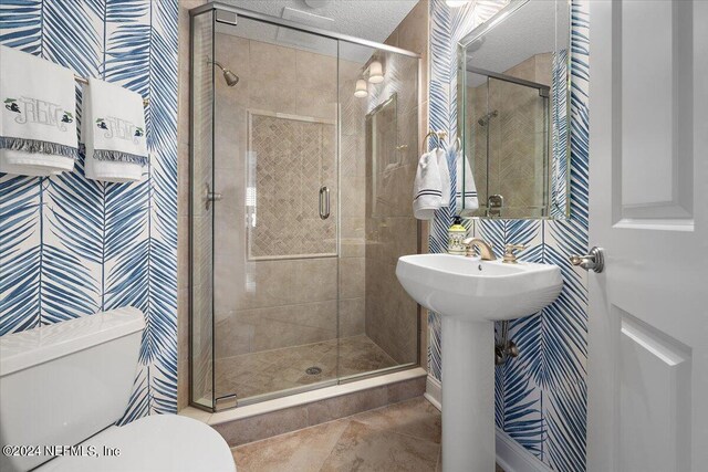 bathroom featuring tile patterned flooring, walk in shower, and toilet