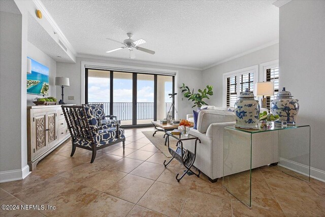 living room featuring light tile patterned floors, a wealth of natural light, and crown molding