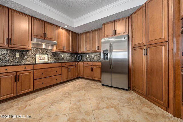 kitchen featuring crown molding, tasteful backsplash, light tile patterned floors, and stainless steel refrigerator with ice dispenser