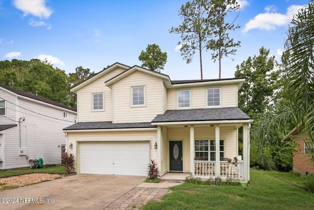 view of front facade featuring covered porch, a front yard, and a garage