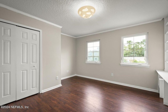 unfurnished bedroom with crown molding, a closet, dark hardwood / wood-style flooring, and a textured ceiling