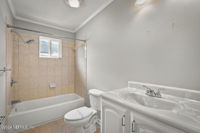 full bathroom with tile patterned flooring, a textured ceiling, toilet, tiled shower / bath combo, and vanity