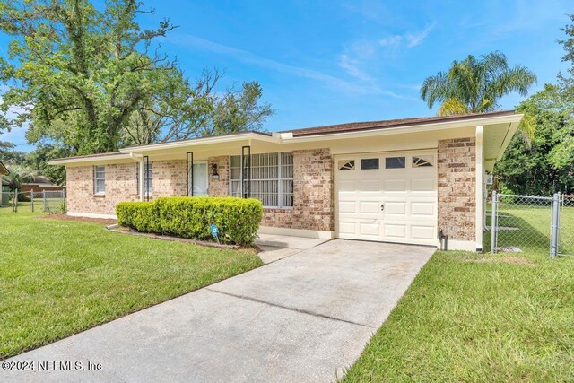 single story home featuring a front yard and a garage