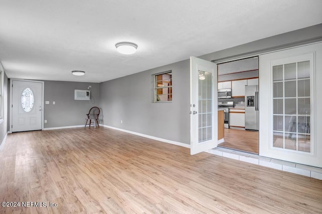 interior space with light hardwood / wood-style flooring and french doors