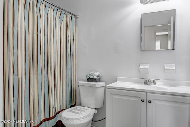 bathroom featuring toilet and vanity